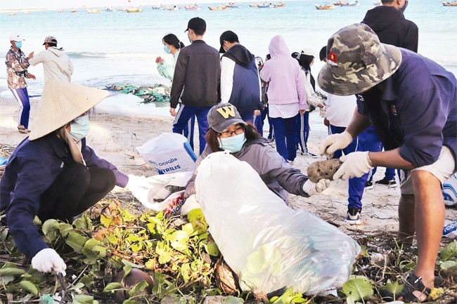 Tình nguyện viên dọn rác ở Ninh Hòa. Ảnh: THÁI THỊNH