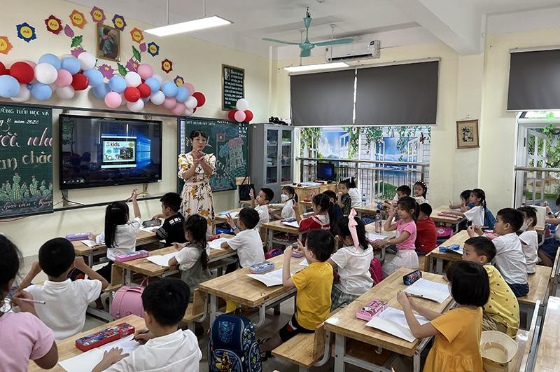 Giáo viên Trường tiểu học và THCS Hoàng Hoa Thám (thành phố Bắc Ninh, tỉnh Bắc Ninh) hướng dẫn học sinh cầm bút. (Ảnh THÚY QUỲNH)