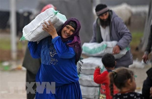 Người tị nạn Syria nhận hàng viện trợ tại trại tị nạn ở thị trấn Mehmediye, Syria. (Ảnh: AFP/TTXVN)